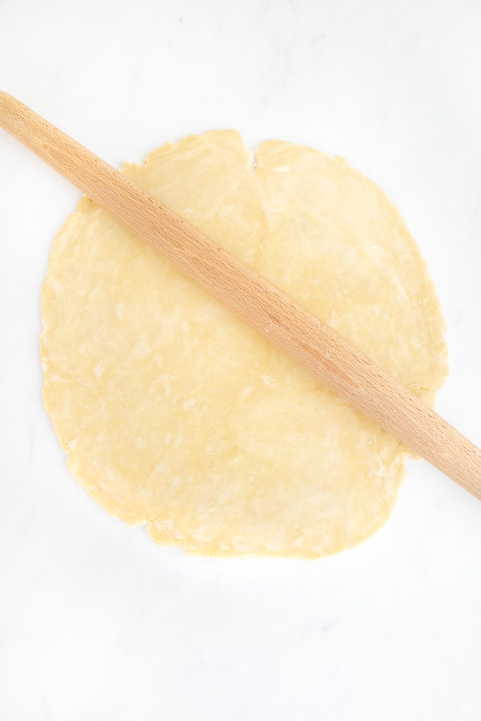 Rolling out French apple tart dough with rolling pin